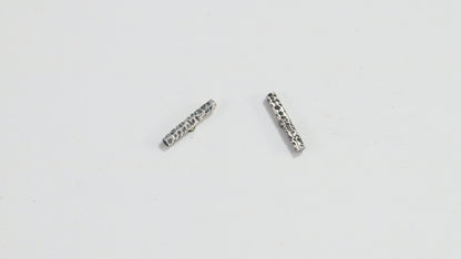 Silver bar studs with a rough hammer texture.